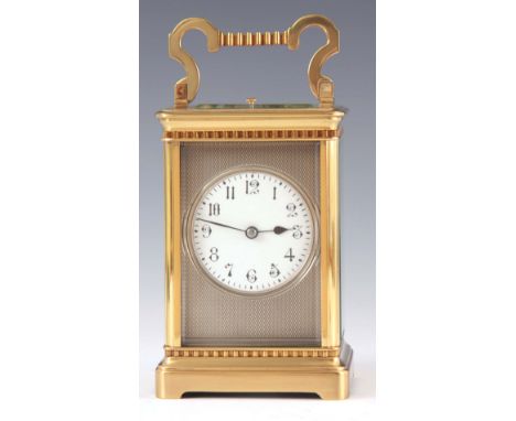 A LATE 19th CENTURY FRENCH REPEATING CARRIAGE CLOCK the decorative moulded brass case enclosing a 6.5cm engine turned silvere