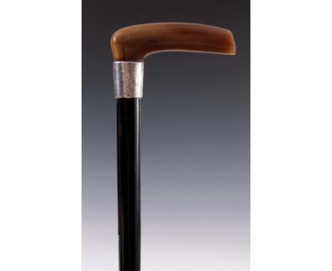 A 19TH CENTURY EBONISED AND RHINO HORN WALKING STICK with engraved silver collar 84cm overall.