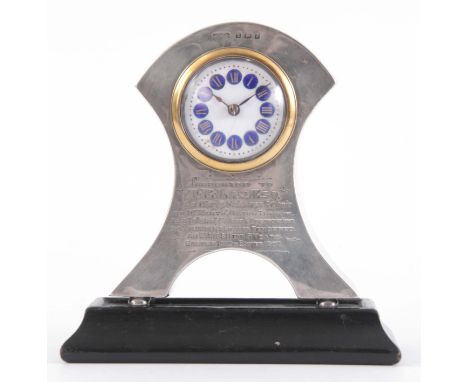 AN EARLY 20th CENTURY SILVER MANTEL CLOCK with arched case enclosing a porcelain dial with blue enamel Roman numerals frontin