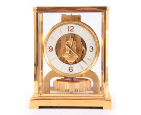 A GILT BRASS CASED JAEGER-LECOULTRE ATMOS CLOCK with white chapter ring having gilt Arabic numerals and baton markers frontin