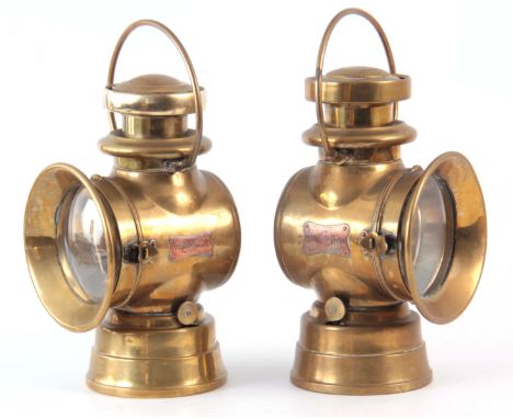 A PAIR OF BRASS LUCAS 724 'KING OF THE ROAD' OIL SIDE LAMPS with two-tier chimneys and loop handles 32cm high