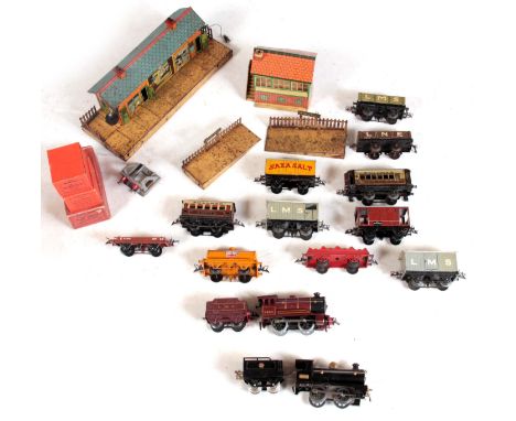 A COLLECTION OF EARLY 20TH CENTURY O GAUGE MODEL TRAINS, including two locomotives and tenders, some rolling stock, and litho