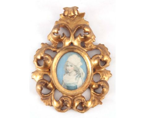 AN EARLY 19TH CENTURY PORTRAIT MINIATURE OF A GIRL, wearing a headscarf in a carved gilded rococo Florentine frame, image 60c