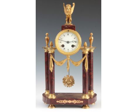 A LATE 19th CENTURY FRENCH ORMOLU AND ROUGE MARBLE MANTEL CLOCK with sphynx finial and four marble pillars, spring driven eig