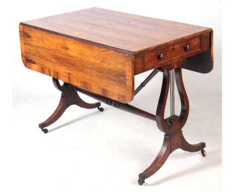 AN UNUSUAL REGENCY OLIVE WOOD SOFA TABLE the hinged top having a cross-banded edge and two end drawers fitted with turned kno