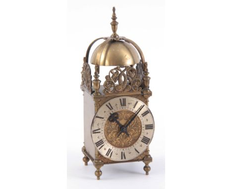 AN EARLY 20th CENTURY LANTERN STYLE MANTEL CLOCK of typical forme enclosing an eight-day spring driven movement 30cm high
