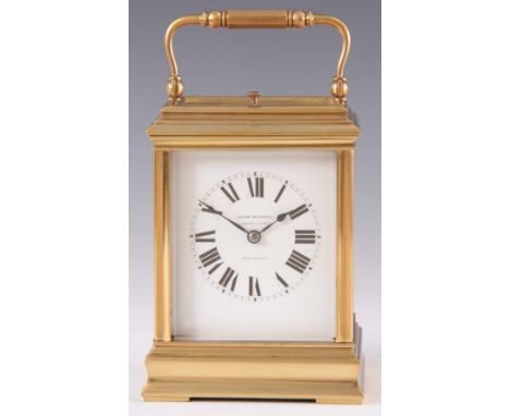 AN EDWARDIAN FRENCH BRASS CANNELEE CASED REPEATING CARRIAGE CLOCK the moulded case with hinged handle enclosing a 7cm porcela