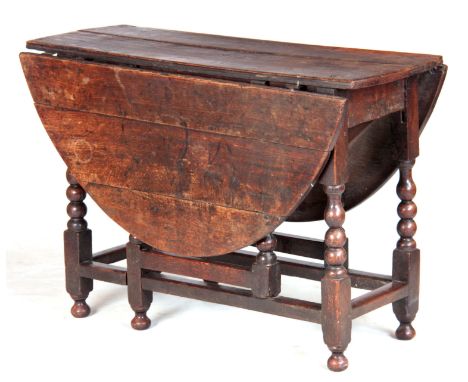 AN EARLY 18TH CENTURY OAK DROP LEAF GATELEG TABLE with bobbin turned legs 106cm wide 42cm deep 70cm high.
