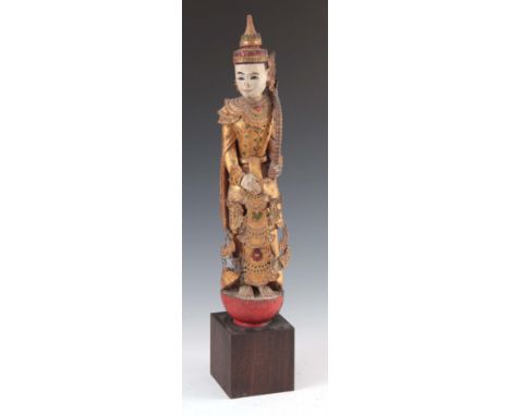 A CARVED STATUE OF A WOODEN BUDDHA 69cm high.