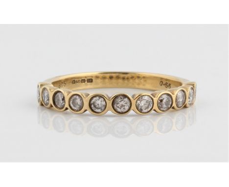 A hallmarked 9ct yellow gold diamond half eternity ring, bezel set with eleven round brilliant cut diamonds, total diamond we