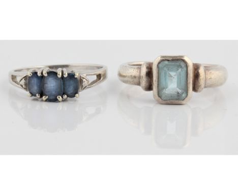 A hallmarked 9ct white gold three stone tanzanite ring, ring size P½, together with a blue topaz ring, stamped 925, ring size