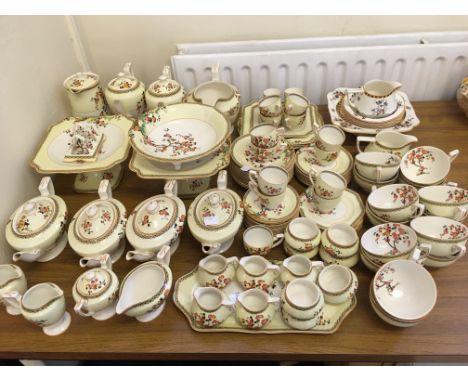 An approx. 100 piece Crown Ducal tea and coffee service in blossom tree on yellow background design, including jugs, teacups,