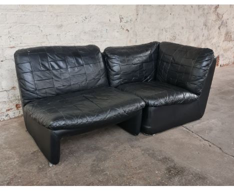 A mid 20th century black leather upholstered two piece sofa suite. IMPORTANT: Online viewing and bidding only. Collection by 