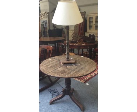 An 18th century oak tilt top tripod table (a.f), 93cm by 73cm, together with a South East Asian carving converted to a table 