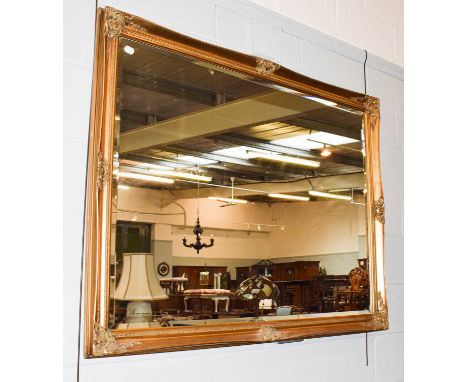 A large 20th century gilt framed wall mirror with bevelled glass, 135cm by 104cm