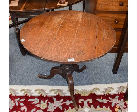 A George II provincial oak tilt top tripod table, 78cm by 72cm; together with a George III mahogany foldover tea table, 88cm 