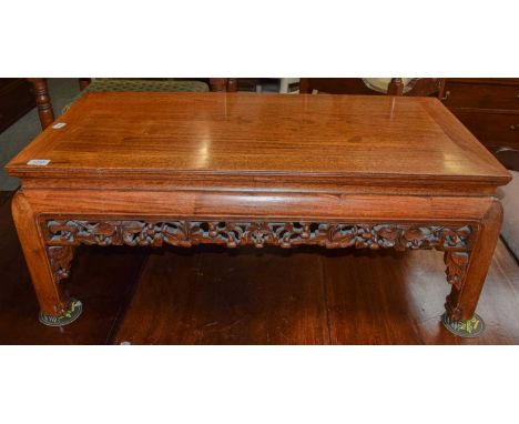 A Chinese carved hardwood coffee table, 93cm by 47cm by 36cmCondition report: Two areas of veneer repair to the top. A couple