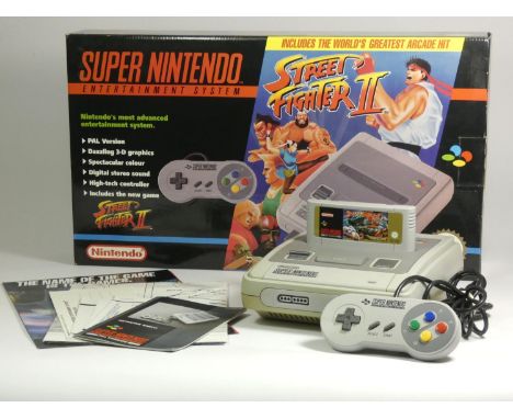 A Nintendo SNES Street Fighter bundle, complete with console, power and AV cables, aerial switch box, Street Fighter II, inst