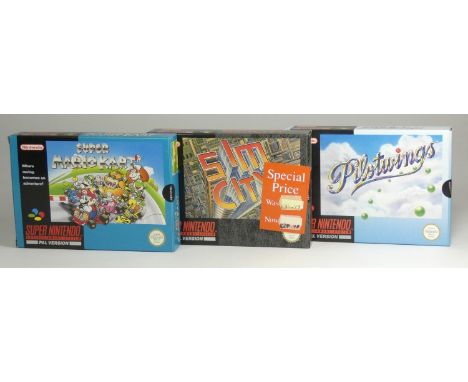 Three Super Nintendo Games, to include Pilotwings (original box, insert, manual, poster and information booklet), Super Mario