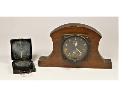 A 35,000 feet altimeter mounted in an oak frame, broad arrow mark to reverse and a Military marching MKI compass, numbered B2