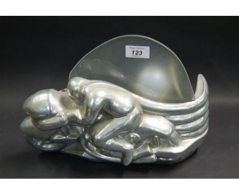 An Art Deco aluminium table lamp in the form of a motorcycle with rider, with raised frosted glass shade