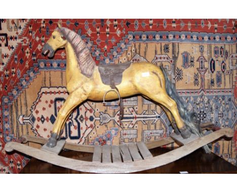 A children's vintage carved wooden rocking horse