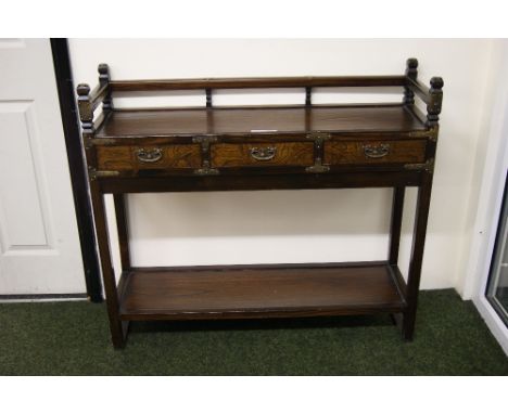 Dark wood console table with three short drawers