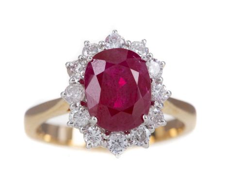 RUBY AND DIAMOND RING,the oval ruby of approximately 3.42 carats, within a round brilliant cut diamond halo totalling approxi