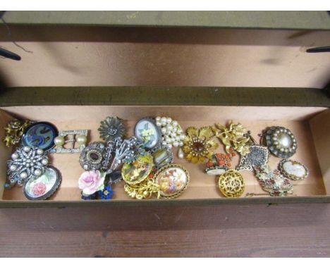 A box of vintage brooches