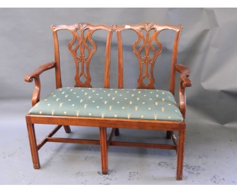 A mahogany Chippendale style two seater settee with pierced and carved splats 