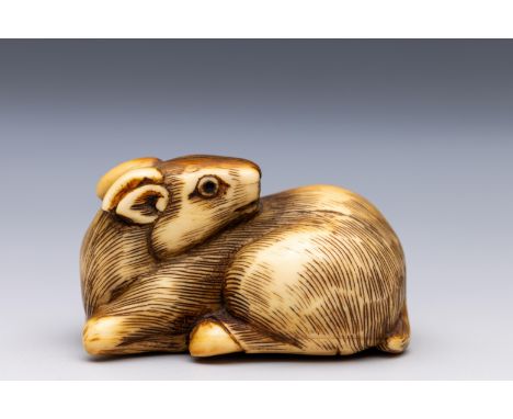 Japan, an ivory netsuke, Edo period (1603-1868), late 18th/ 19th century, shaped as a reclining stag carved with its head tur