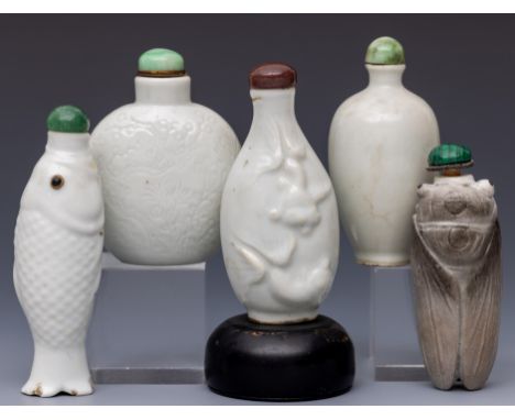 China, five white-glazed ceramic snuff bottles and stoppers, late Qing dynasty (1644-1912), one shaped as a cricket, one as a