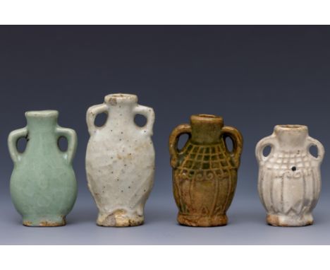 China, four ceramic miniature vases, Ming dynasty (1368-1644) each of flattened shape and moulded with lug handles, two cover