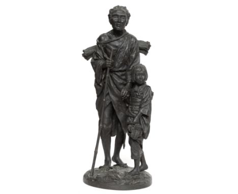 Japan, black patinated bronze okimono, depicting blind woman with child, Meiji (1868-1912); Placed on natural circular base, 