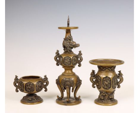 China, a three-piece bronze altar set, 19th century, comprising a vase, a censer and a pricket candlestick, all moulded with 