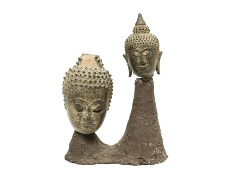 Thailand, two bronze Buddha heads, ca. 16th-17th century, smallest one with remnants of gilding. Placed on a custom made cera