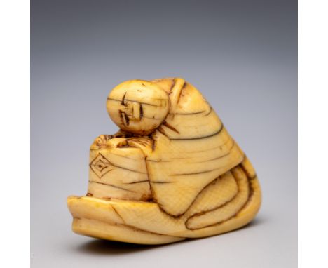Japan, an ivory netsuke, Edo period (1603-1868), late 18th/ 19th century, carved as a kannushi reclining over a drum (yellowi