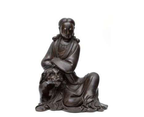 China, wire-inlaid bronze model of Guanyin atop a dragon, 19th century, the deity dressed in flowing robes and leaning on a d