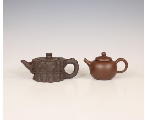 China, two Yixing earthenware teapots and covers, modern, one with rounded sides and of even tone, the other modelled as a tr