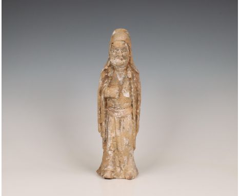 China, pottery model of an official, probably Tang dynasty (618-906), standing wearing long robes over his protruding belly (