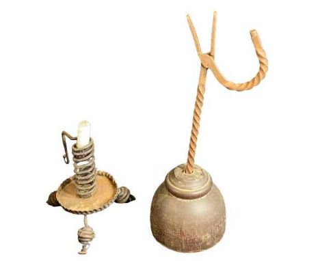 19TH CENTURY RUSH LIGHT HOLDER on a hard wood base, 40cms tall and a rustic metalware candle holder
