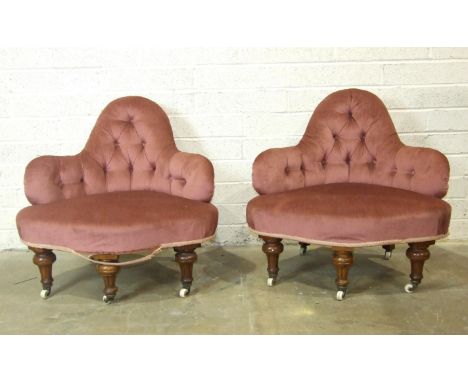 A pair of Victorian walnut upholstered corner chairs with button backs and serpentine seats, on fluted turned legs with brass