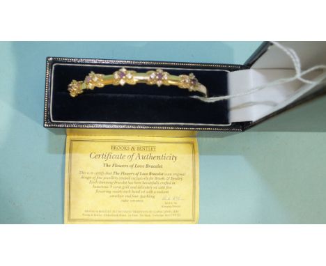 A Brooks &amp; Bentley 9ct gold bangle set with five amethyst and cubic zirconia flower-head clusters, 9g, boxed with certifi