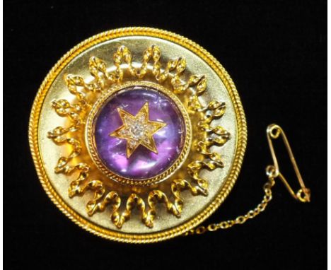 A Victorian yellow gold circular brooch c1860, set amethyst cabochon overlaid with old brilliant and rose-cut diamond cluster