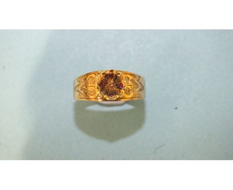 A gold ring set raised rosette set with diamond points and small ruby cabochons, on engraved mount, size Q, 2.3g, (tests as 1
