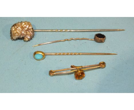 A Victorian stick pin set natural baroque pearl in gold mount, on steel pin, two other stick pins and a small gold brooch pin