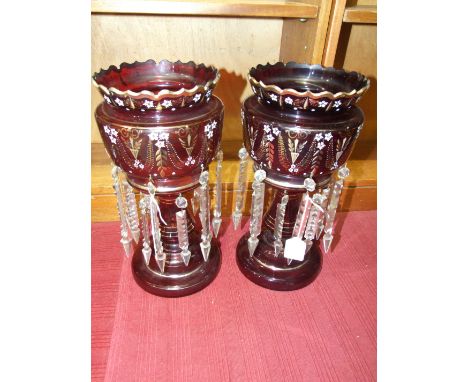 A pair of ruby glass lustre vases with gilt and white enamel decoration and clear glass drops, 36cm high.