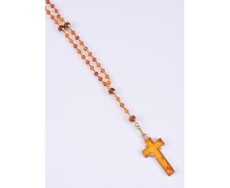 
	
		J. B. SORENSEN, A HEATED AMBER ROSARY
		The amber bead chain suspending an amber cross in an engraved mount, stamped 750