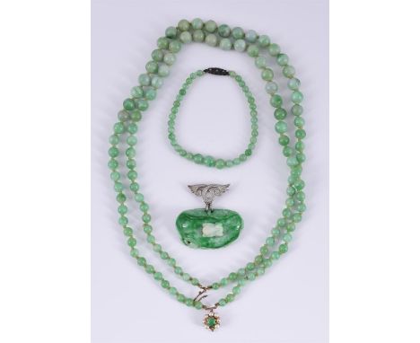 
	
		A JADEITE BEAD NECKLACE, A CARVED JADE FROG BROOCH/PENDANT AND BRACELET 
		The graduated polished jadeite jade bead neck