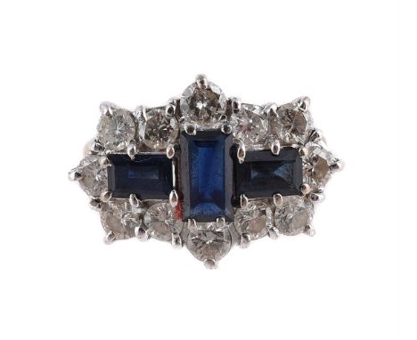 
	
		AN 18 CARAT GOLD, SAPPHIRE AND DIAMOND DRESS RING 
		LONDON 1979 
		The rectangular step cut sapphires within a border o